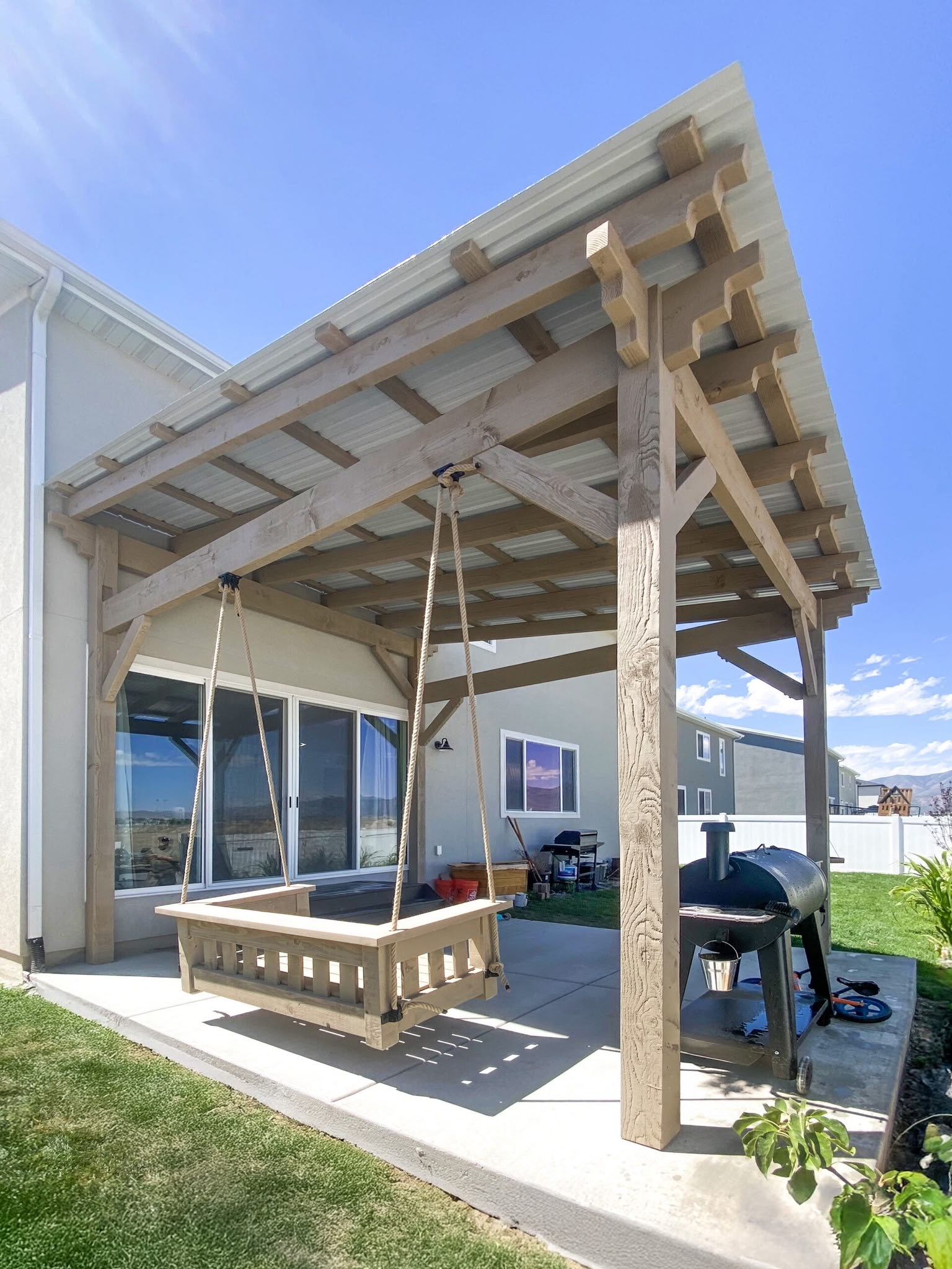 Covered pergola with hanging swing